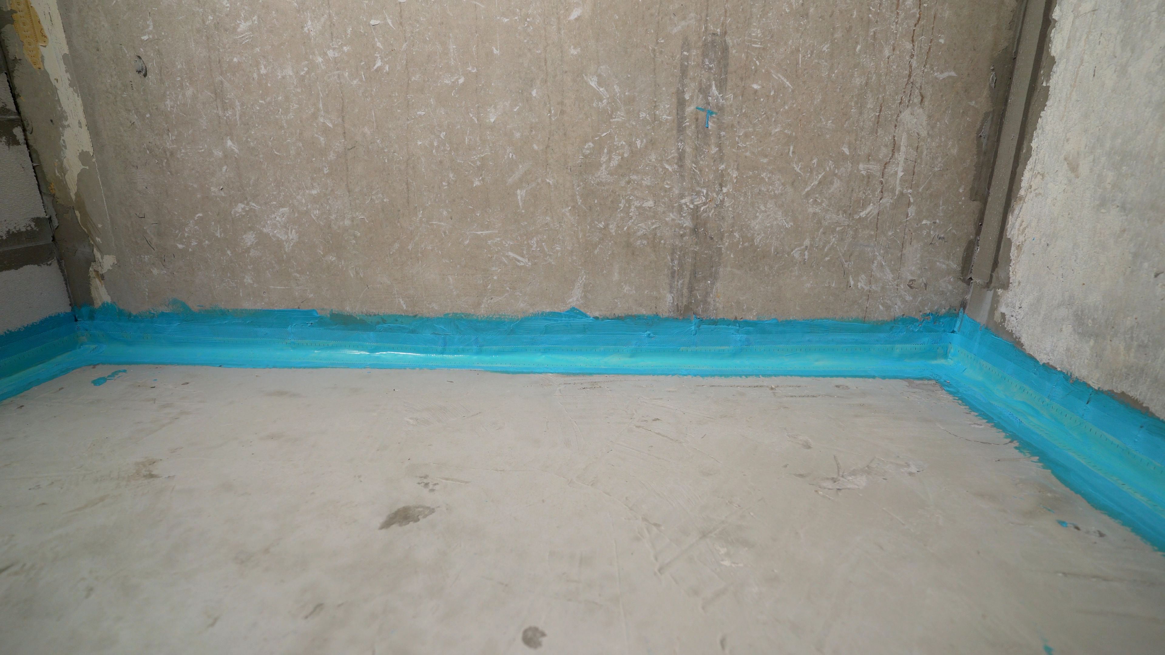 Working Brush For Waterproofing Walls And Floors. Blue Waterproofing. Waterproofing The Floor With Blue Mortar